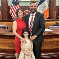 New York City Council Member-elect Kristy Marmorato, right, is sworn in at City Hall alongside her husband Gino Marmorato and 7-year-old daughter Renata on Wednesday, Dec. 6, 2023.