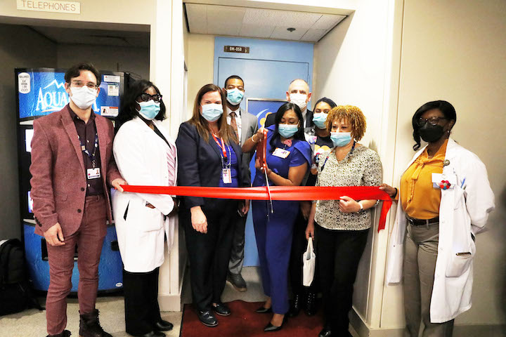 A group photo with staff members before the ribbon cutting.