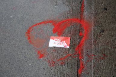A community member added the red sand on the floor into pavement cracks and also added a heart with the Red Sand Project sign to bring awareness of sex trafficking.