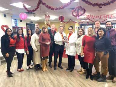 Bronx Center Administrator Jeff Sicklick, middle, holds Centers Health Care’s AHA Second Century Medallion, surrounded by AHA, Centers Health Care and Bronx Center staff.