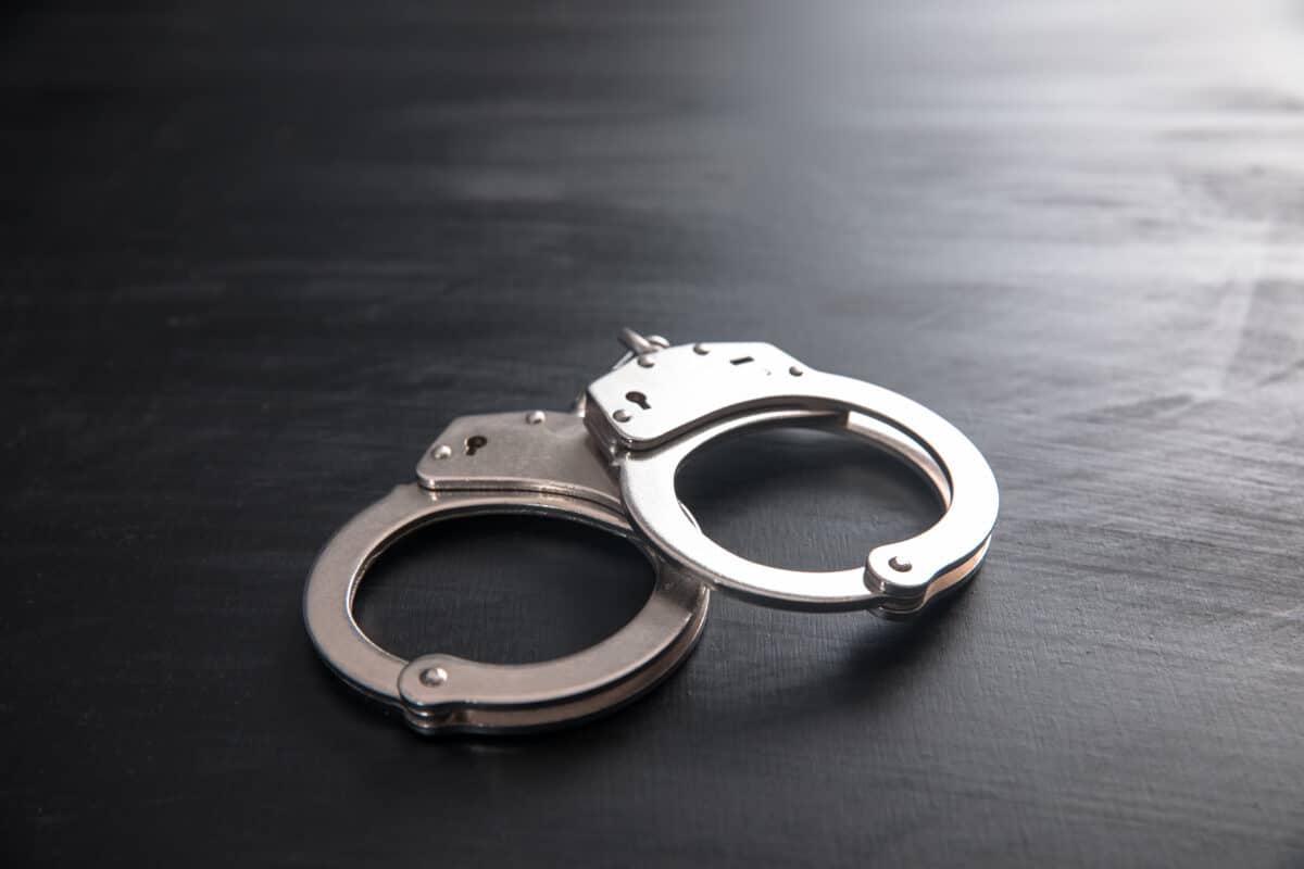 handcuffs on wooden background