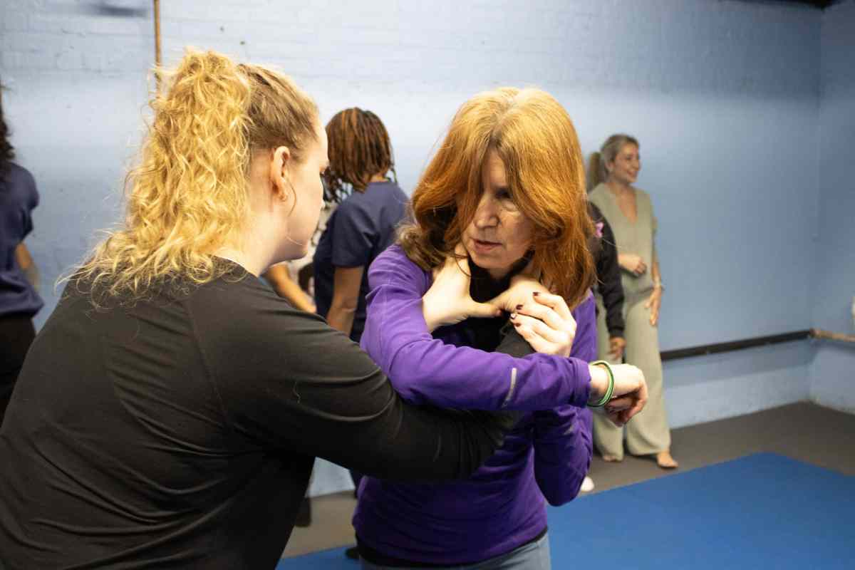 Maggie Costa assists at the women's self defense class.