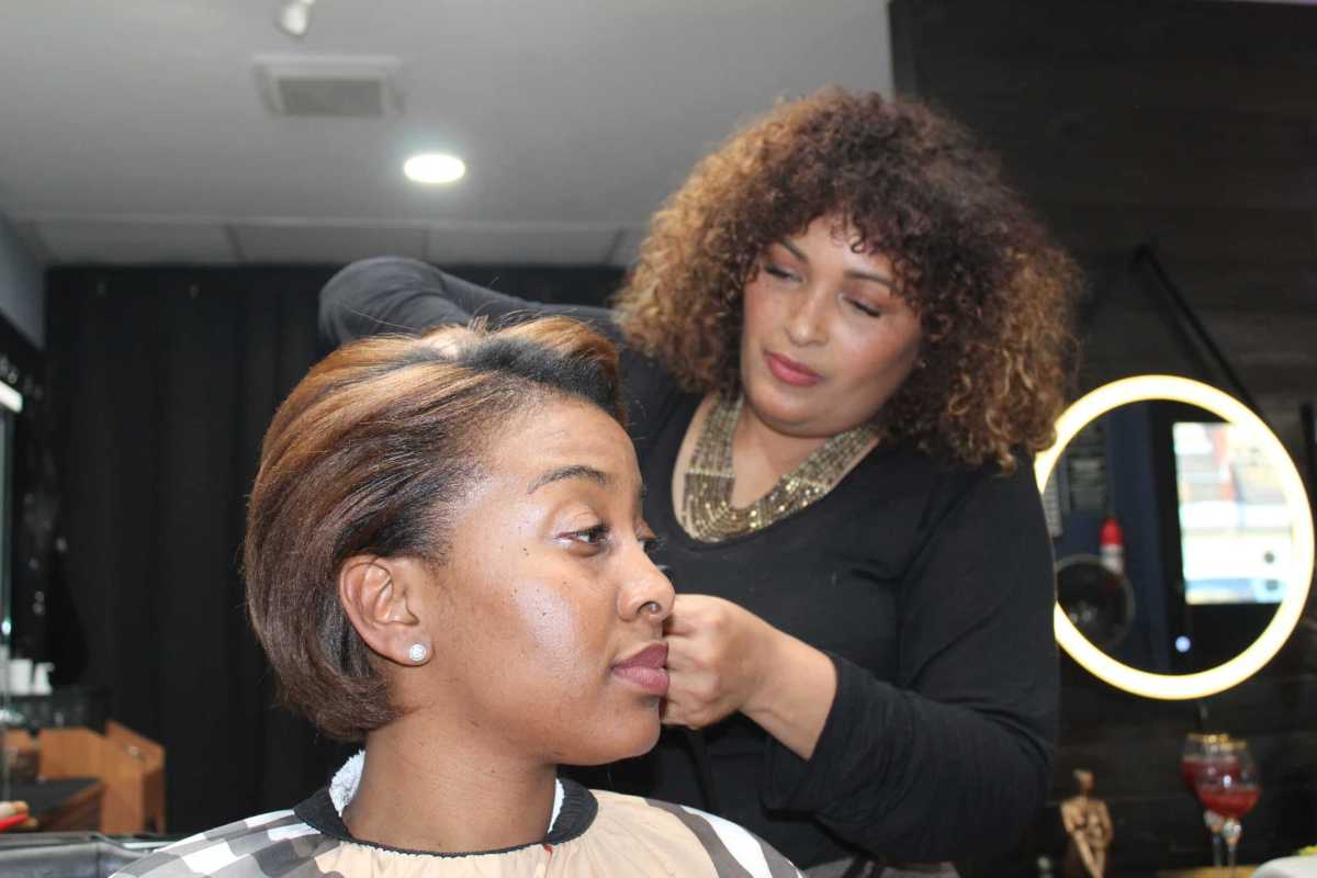 Denisse Uribe Palin styles Kerene Edie's hair at her salon Hair By Dee in Van Nest on Tuesday, Feb. 20, 2024.