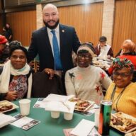 Councilmember Rafael Salamanca poses for a photo with three community members at the Black History Month celebration.