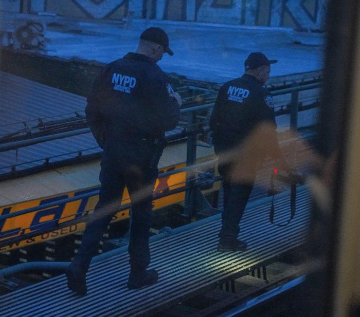 NYPD surveys the tracks at Mount Eden Avenue station following the subway shooting on Monday, Feb. 12, 2024.