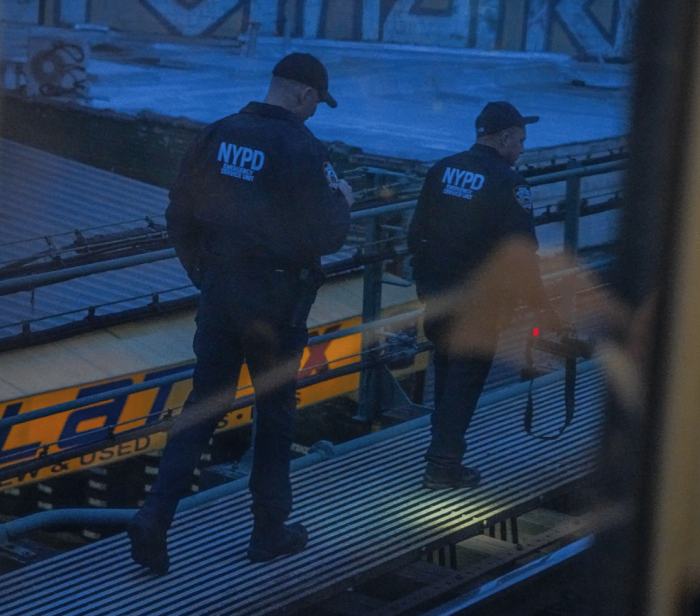 NYPD surveys the tracks at Mount Eden Avenue station following the subway shooting on Monday, Feb. 12, 2024.