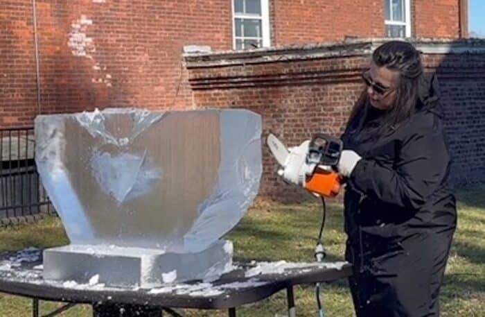 Morris Park resident and artist Lovie Pignata begins carving her piece, 'Smitten', from a block of ice during the Governors Island Ice Sculpture Show. 'Smitten' will be recreated in Times Square for viewing for Valentine's Day.
