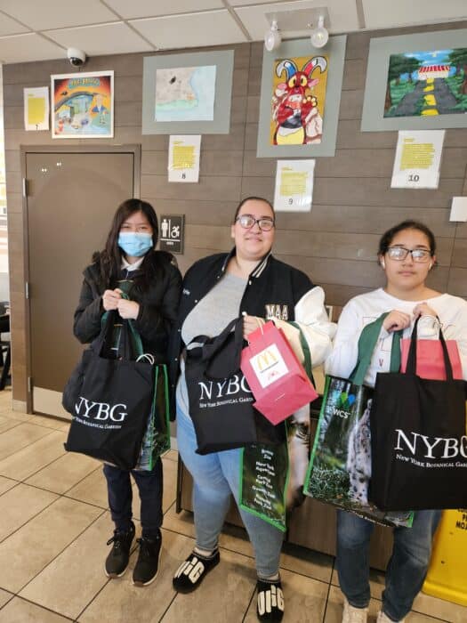 The three winners of the art contest pose with their prizes.