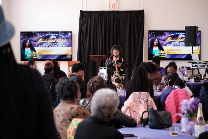 Teenage college student Jinell Mejia is the first speaker during the Black Girl Magic: Economic Empowerment event at the South Bronx's Andrew Freedman home on Saturday, March 16, 2024. She read poetry to a packed room full of her peers and elders.