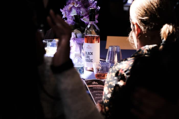 Black Girl Magic beverages, which share their name with the event, sit on every table in the Andrew Freedman Home on Saturday, March 16, 2024.