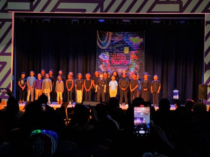 The crowd watches as Zeta Charter School students prepare to perform a routine as part of the hip hop showcase.