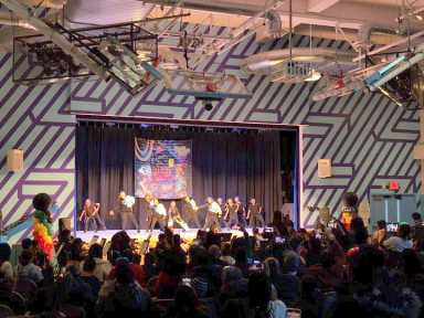 Students perform a choreographed dance routine to a gathered crowd as part of the hip hop showcase.