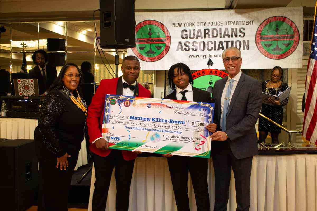 A group photo with Matthew Killion-Brown holding his Guardians Association Scholarship.