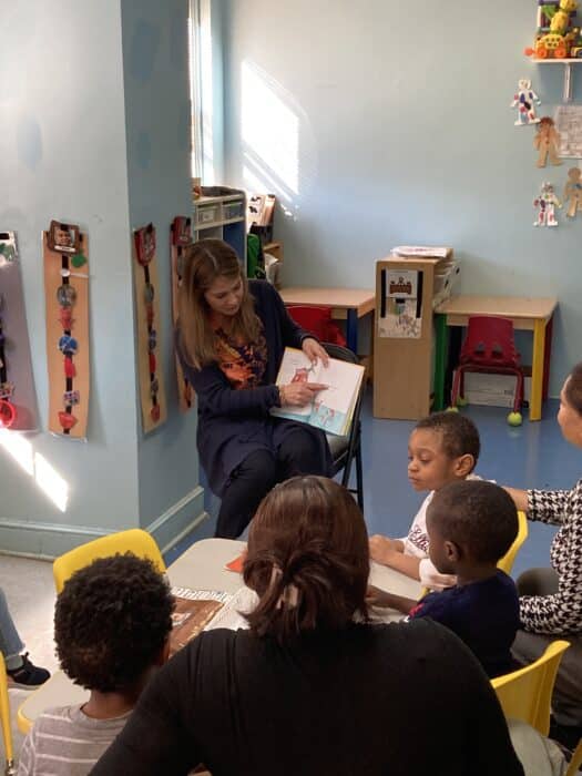 A woman reads to a group of children at Birch Pelham Bay Early Childhood Center.