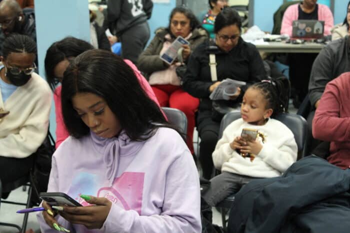 The crowd takes out their cell phones after Bronx Council Member Althea Stevens encourages them to text Mayor Eric Adams notes of opposition to his proposed budget cuts on Tuesday, March 5, 2024.