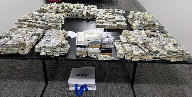 More than 26 pounds of cocaine and $3 million in cash is displayed after law enforcement conducted a drug raid in Norwood on Wednesday, March 20, 2024.