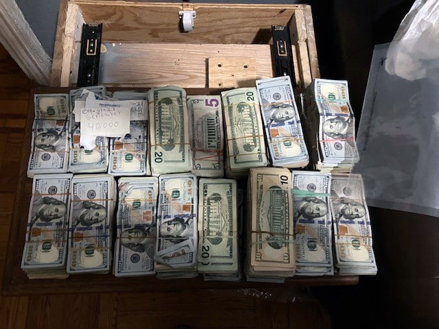 A nightstand is filled with dated cash.