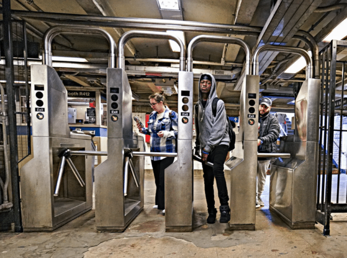 Someone steps over a turnstile at the Hunts Point Station in the Bronx.