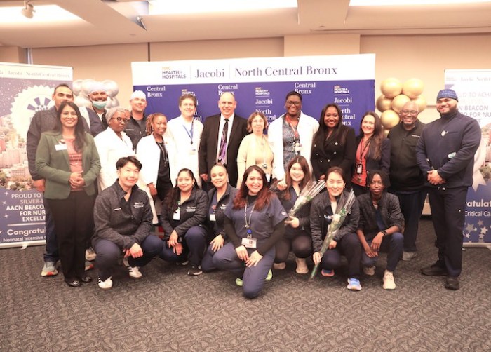NYC Health + Hospitals/Jacobi leadership and staff pose for a photo.