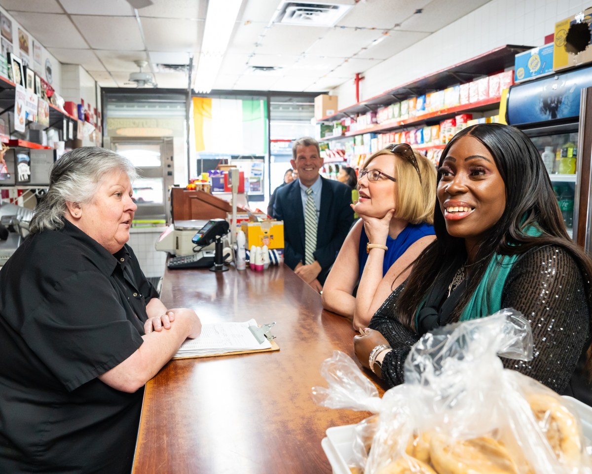 Bronx Borough President Vanessa L. Gibson (right) and Consul General of Ireland Helena Nolan sit together at Prime Cuts Irish Butcher during the tour of Woodlawn.