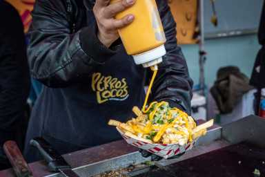 Event goers can indulge in a variety of foods, including nacho fries at the Bronx Night Market.