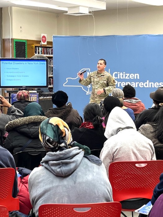 Program presenter Sgt. Ortiz, from the United States Air Force, gives audience members information about disaster preparedness.
