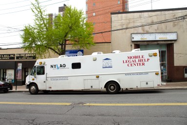 New York Legal Assistance Group's Mobile Legal Help Center parked outside the Office of Council Member Eric Dinowitz, awaiting attendees who made appointments to receive assistance in legal matters. Walk-ins were also accepted.