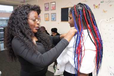 Pamela Damon, executive director at Not On My Watch, Inc. assisting one of the young ladies in preparing for their personal photoshoot.