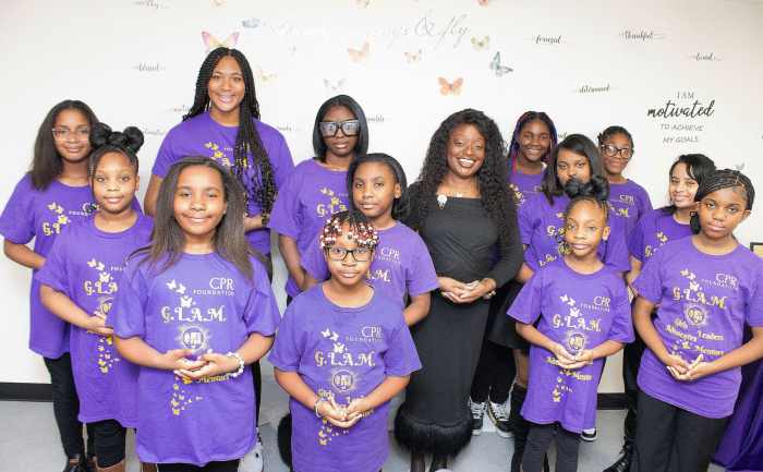 Pamela Damon, executive director at Not On My Watch, Inc. in a group photo with some of the young ladies of Not On My Watch, Inc. who took part in the photo shoot for their Souvenir Journal.