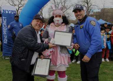 Crusaders for Children's Rights received certificate of appreciation from Never End Love & The 52nd Precinct Community Affairs and PO Echevarria at the Easter Egg Hunt.
