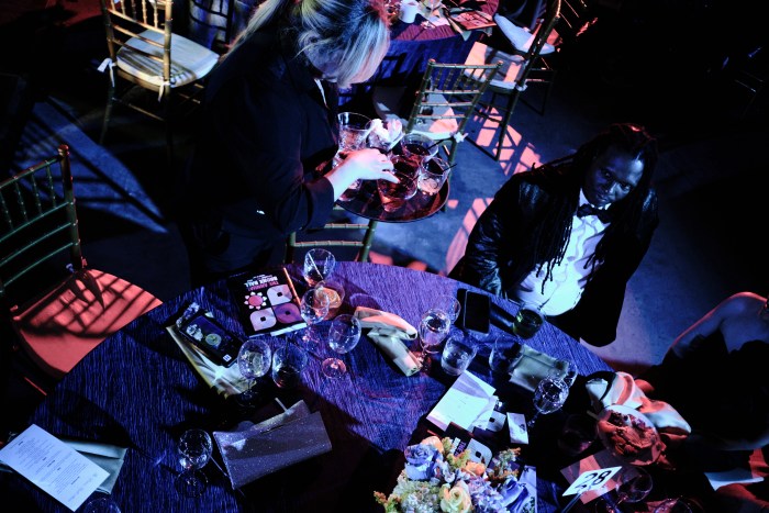A server clears drinks during the Bronx Ball on May 18, 2024.