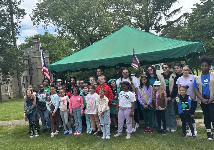 Nearly 50 Girl Scouts honored veterans by placing American flags on gravesites at the Bronx’s Woodlawn Cemetery on Saturday, May 18.