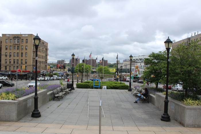 People walk and sit in Lou Gehrig Plaza in the Bronx on Friday, May 10, 2024.