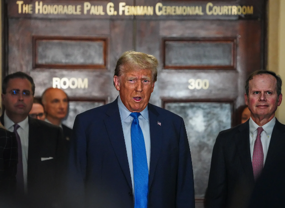 Former President Donald Trump speaks to reporters outside a New York courtroom during his business fraud trial.