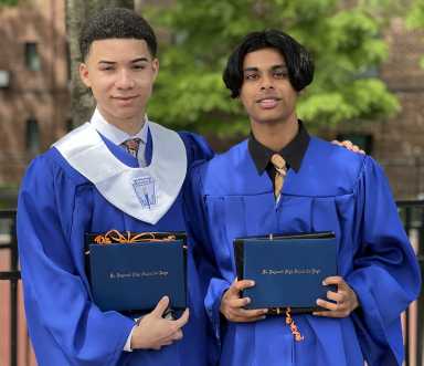 Valedictorian Enmanuel Castillo (left) and salutatorian Joshua Kissoon (right) present their diplomas. Photo courtesy Jennifer Geideman.