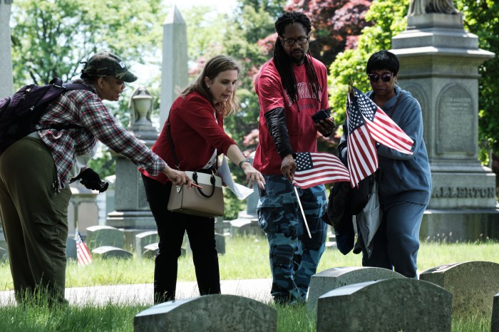 Members of Community Board 7 discuss which gravestone to flag in Woodlawn Cemetery on May 20, 2024.