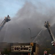 Firefighters battled a four-alarm fire in a row of commercial buildings on Third Avenue in Melrose on Thursday, June 20.