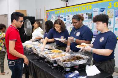 Young troopers serving fathers and all present with food prepared by Chef Christina.