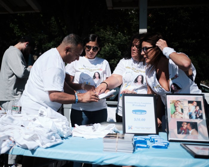 The Christian Rivera Foundation team huddles before speaking to the runners and walkers. The Full Steam Ahead 5K is dedicated to one of the Christian Rivera Foundation Warriors, Maria Kuenster, who is one of the 1% of people diagnosed with GIPG that has survived more than five years. Photographed on June 15, 2024 in Van Cortlandt Park.