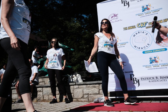 Members of the Cristian Rivera Foundation take the mic to speak to the 5K's participants about the fight against Diffuse Intrinsic Pontine Glioma (DIPG), a cancer that grows its tumor onto the brain stem, affecting the nervous system. Photographed on June 15, 2024.
