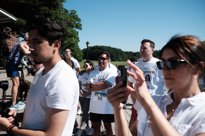 Runners and walkers of the Full Steam Ahead 5K give their rapt attention to the speakers who explain the deadliness of DIPG and the work done by Maria Kuenster's organization Maria's Miracle. Photographed on June 15, 2024.