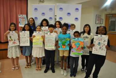 Winning students from the Throggs Neck Community Action Partnership's annual poster contest present their pieces. Photo courtesy Dawn Insanalli