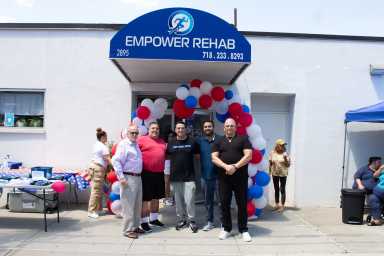 Stephen B Kaufman, Attorney At Law; Anthony Basso, Chairman of the Board at Throggs Neck BID; Thomas Polykarpous, owner and occupational therapist at Empower Rehab; Pierce Arroyo, co-owner and occupational therapist at Empower Rehab; and Bobby Jaen, Throggs Neck Merchants Association executive director in the front of Empower Rehab.