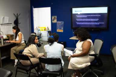 Levern Coger-Sanchez looks over the resume of one of the attendees at a Legal Hand Bronx workshop.