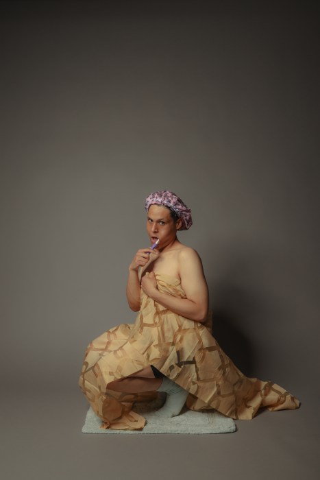 <span class="image-credit">The Bronx-based playwright Adrian Costa preps in the stage bathroom during his Bathroom Play. Photo courtesy Adrian Costa