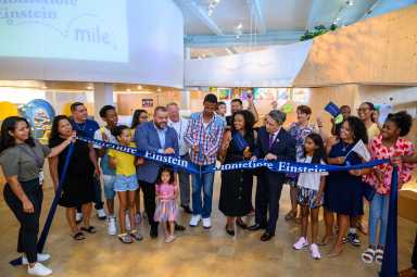 Attendees cheer as the ribbon is cut for the newly marked Montefiore Einstein Mile in Bronx Children's Museum.