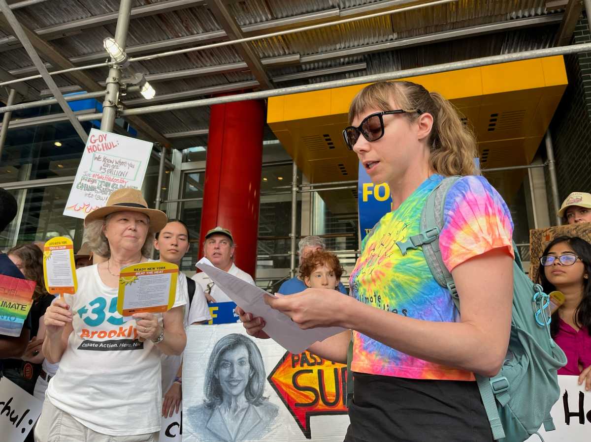 Pelham Parkway resident Sarah Fecht (right) rallied with other advocates for Gov. Hochul to sign the Climate Change Superfund Act, which would require oil companies to pay towards climate change mitigation efforts.