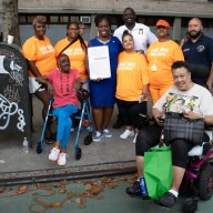 A group photo with Community Council President, Barabara Holmes; Moore House Resident Association members; Bronx Borough President, Vanessa Gibson holding a Proclamation recognizing August 6 as National Night Out; PSA7 Commanding Officer Kwo; Council Member Rafael Salamanca; and Dana Elden, St. Mary's Park Houses Resident Council.
