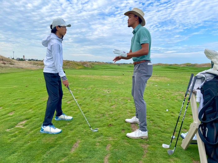 APGA Tour player Andrew Walker gives tips to a young golfer Wednesday at the free juniors clinic at Bally's Golf Links at Ferry Point, sponsored by Farmers Insurance.