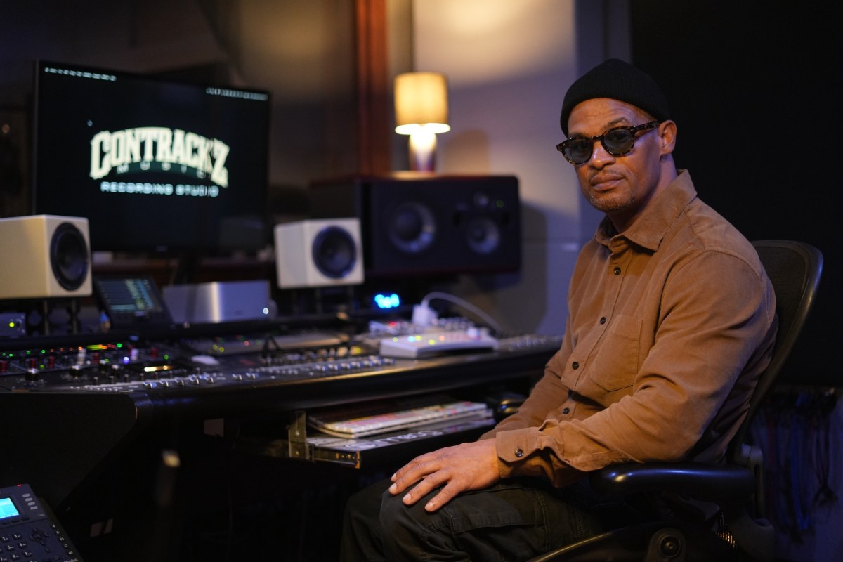 Joe Maldonado sits in front of a sound board at his East Bronx recording studio, Contrackz Recording Studio.